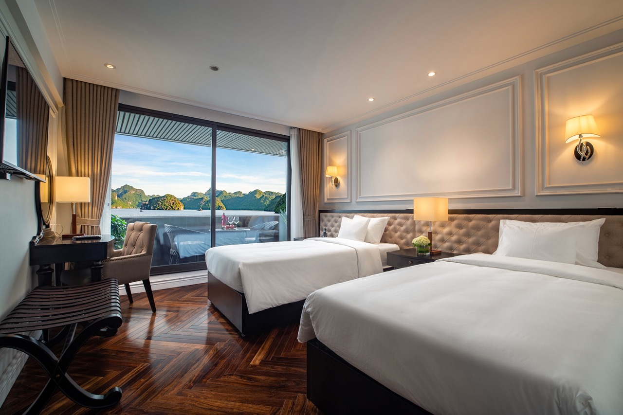 Luxury hotel room with sea view, modern amenities, and balcony overlooking lush mountains. Perfect for travel relaxation.