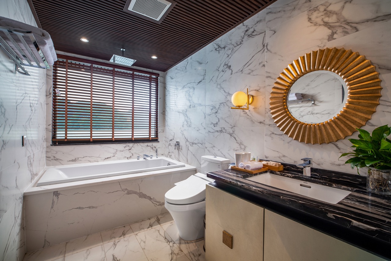 Luxury marble bathroom with bathtub, modern fixtures, and stylish decor for a relaxing experience.