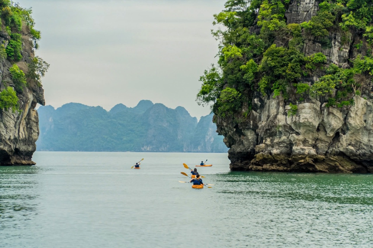 Kayaking among limestone karsts in Ha Long Bay, Vietnam.