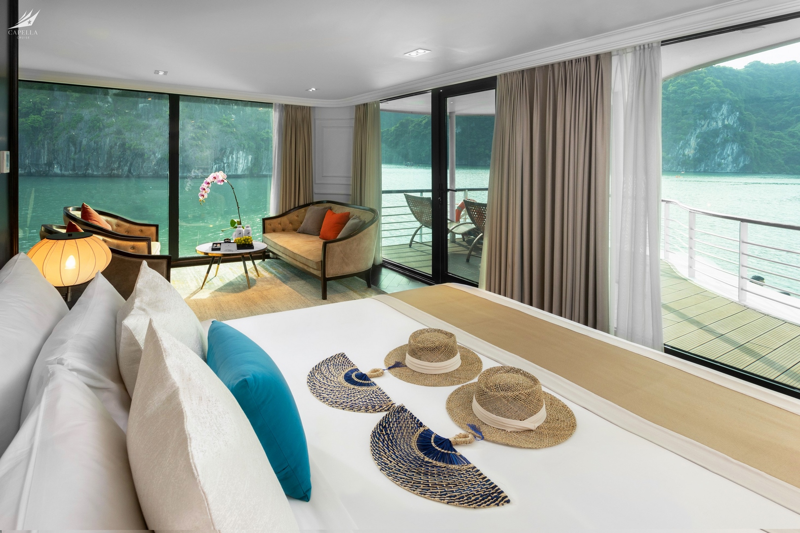 1. Modern hotel room with river view, balcony, and comfortable seating area.