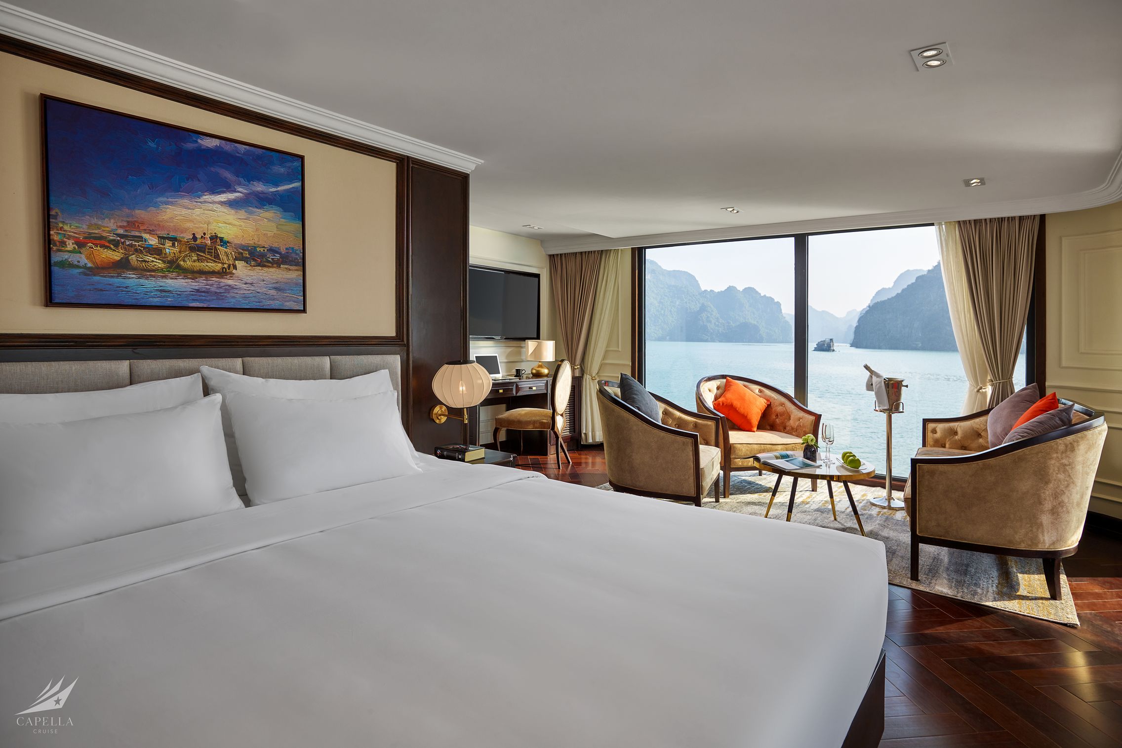 Sea view luxury hotel room in Vietnam with elegant furnishings and floor-to-ceiling windows.