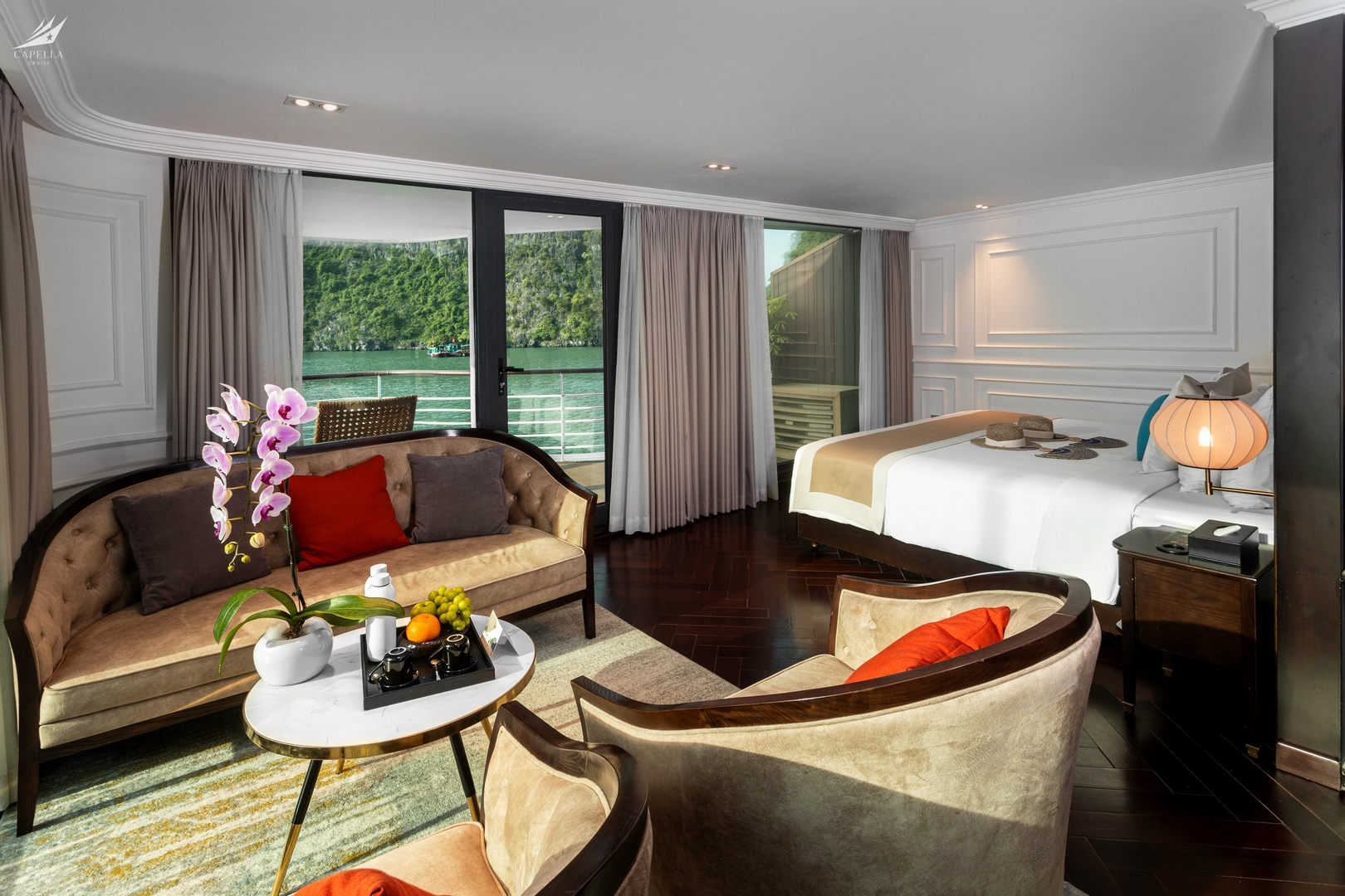 Elegant hotel room with balcony view of lush green water and surrounding mountains in Vietnam, perfect for luxury travel.