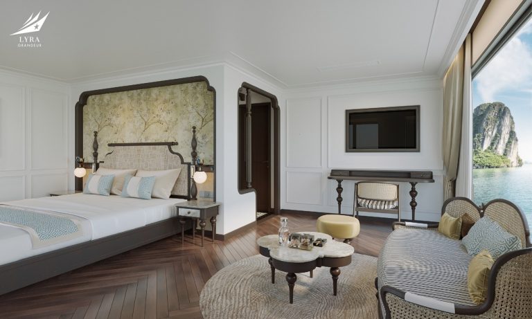 Luxurious hotel room with elegant decor and scenic ocean view of limestone cliffs. - Lyra Grandeur Lan Ha Bay Cruise