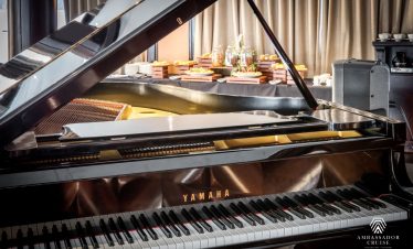 Luxurious interior of the cruise with a grand piano and cozy ambiance, perfect for relaxing during H.