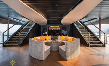 Luxurious cruise lounge with panoramic views of Halong Bay, perfect for relaxing and enjoying the sc.