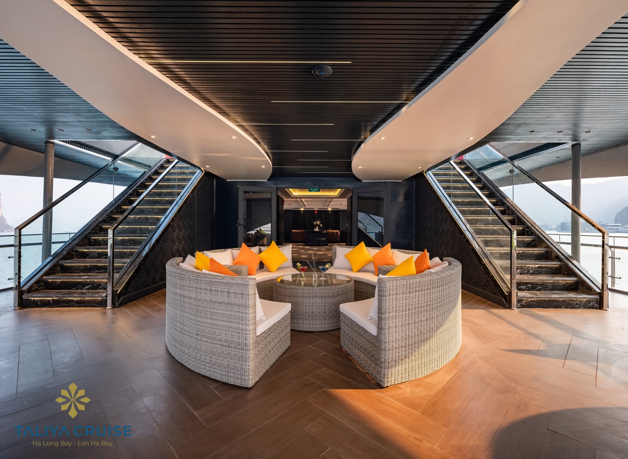 Luxurious cruise lounge with panoramic views of Halong Bay, perfect for relaxing and enjoying the sc.