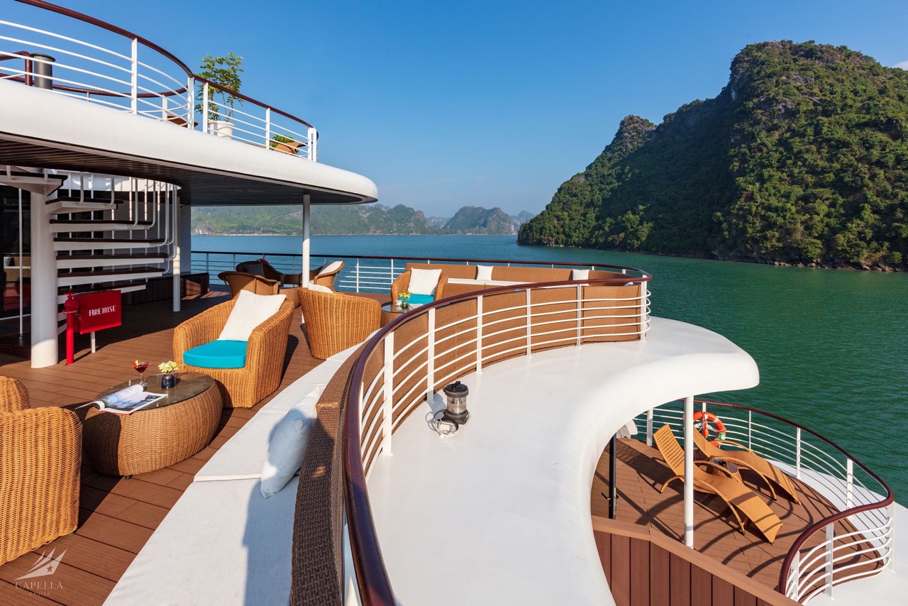Relaxing yachting deck overlooking tropical islands and emerald waters.