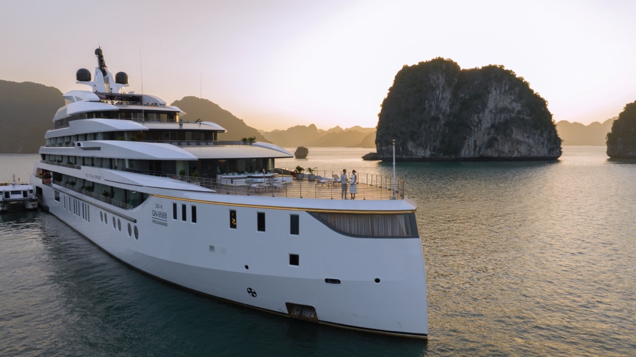 Luxurious yacht cruising in Halong Bay, Vietnam with scenic limestone islands.