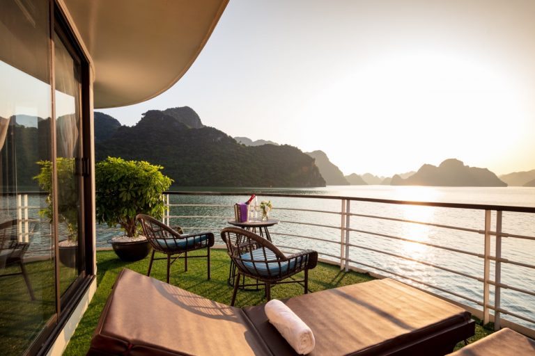 Stunning view from a cruise balcony in Halong Bay during sunset, perfect for relaxing and enjoying s.