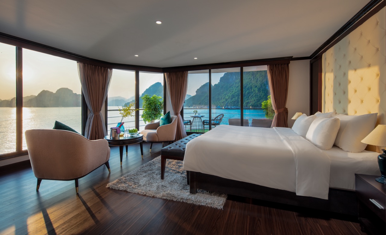 Stunning view from a cruise balcony in Halong Bay, showcasing tranquil waters and majestic limestone.