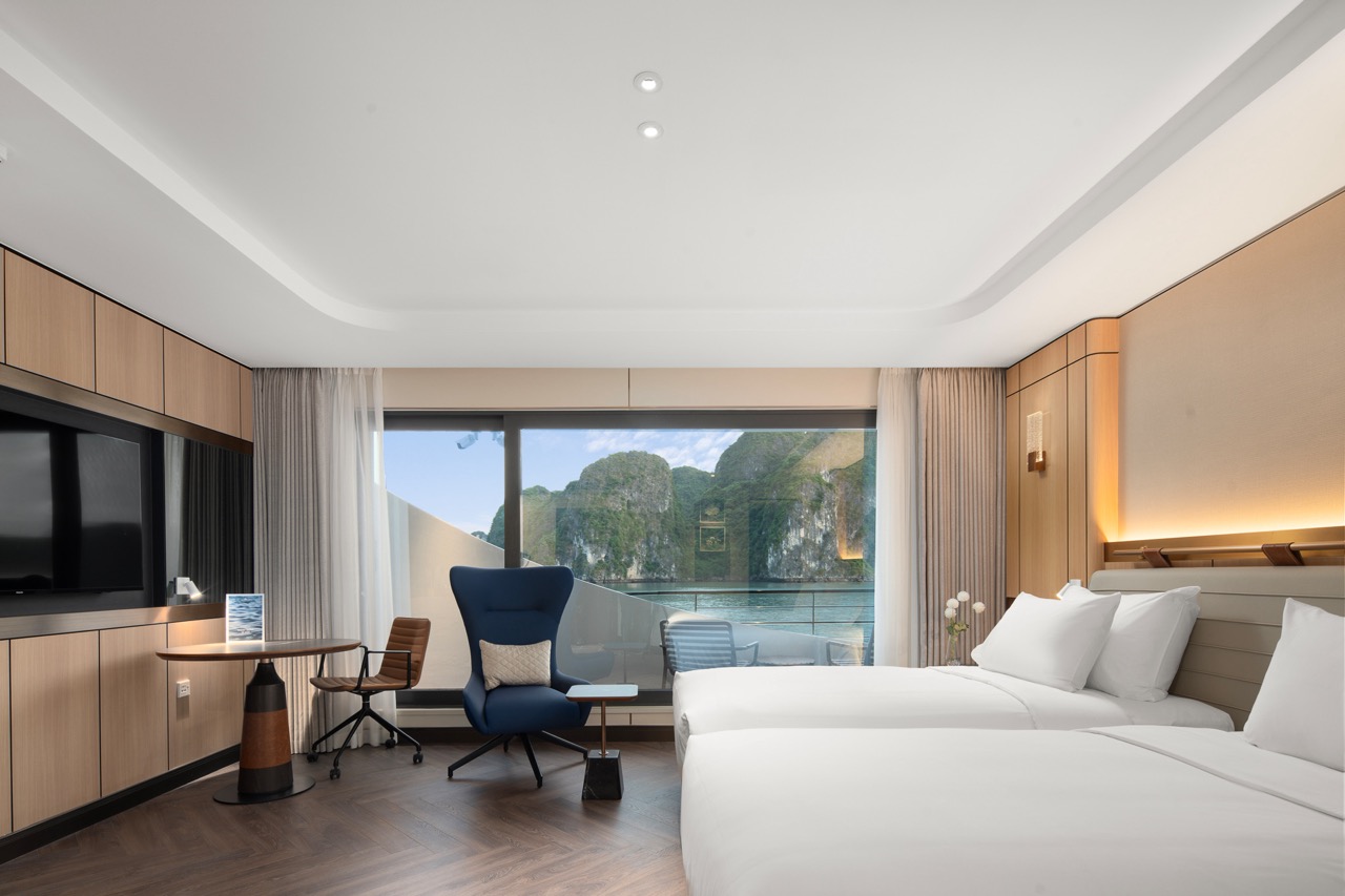 Modern hotel room with ocean view, king-size beds, and stylish interior in Vietnam.