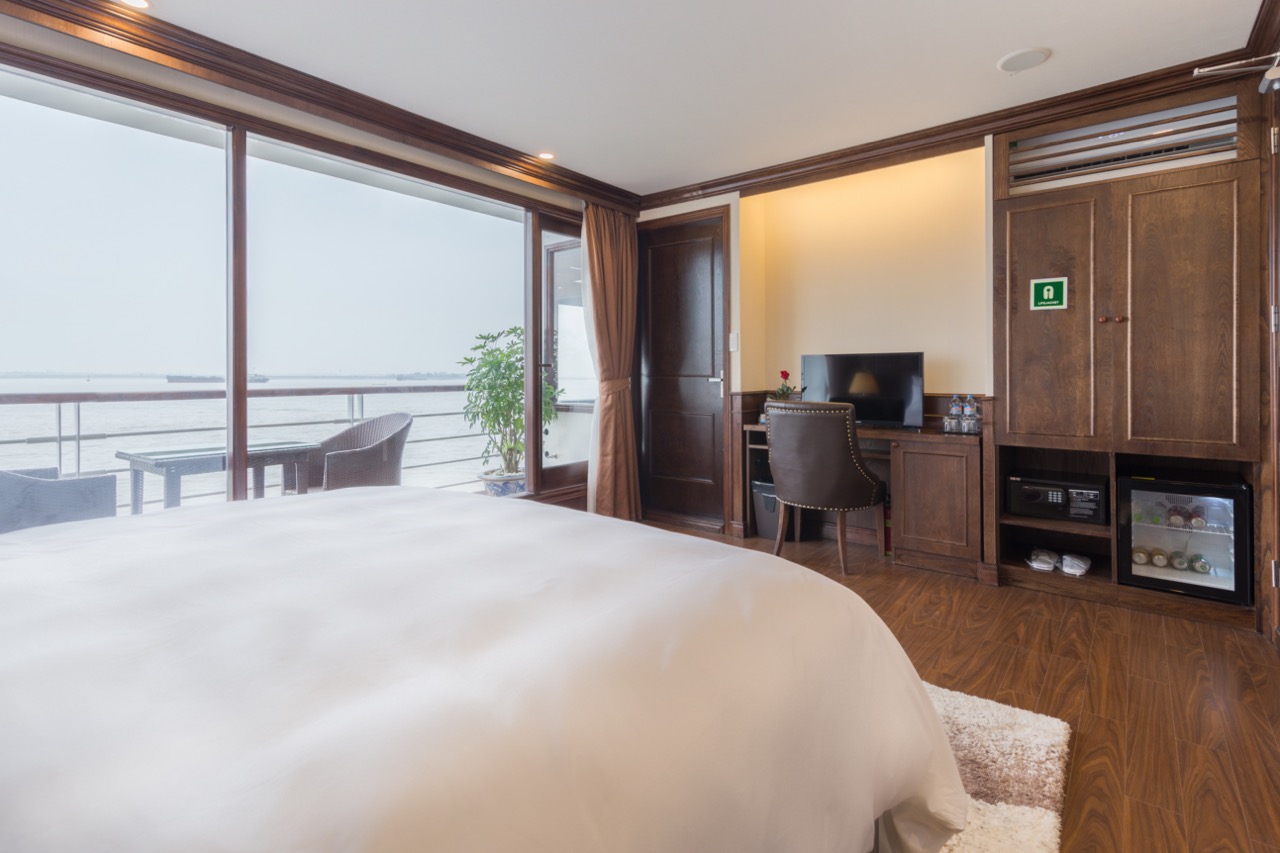 Balcony view of Halong Bay from a luxury cruise, showcasing elegant interior and scenic vistas.