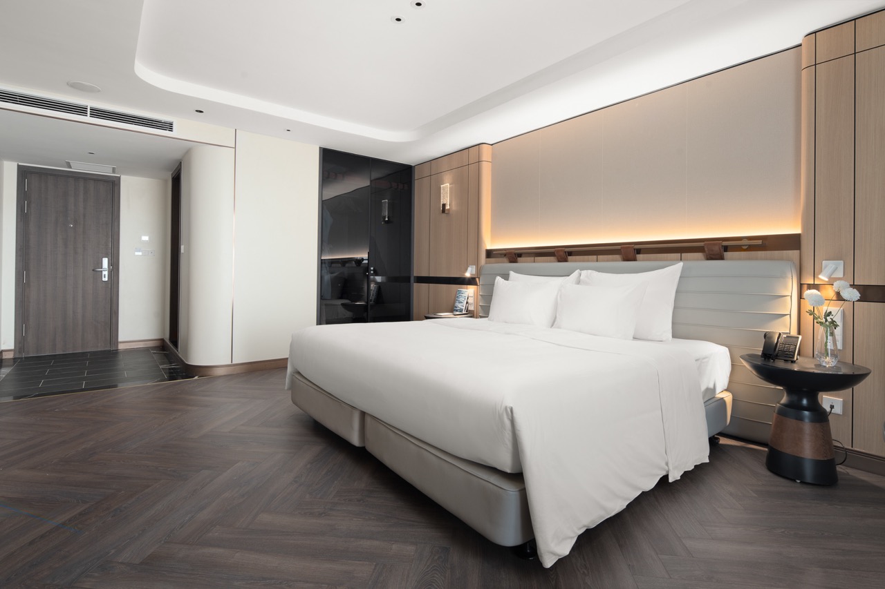 Elegant hotel bedroom with modern design and cozy ambiance, perfect for relaxing stays in Vietnam.