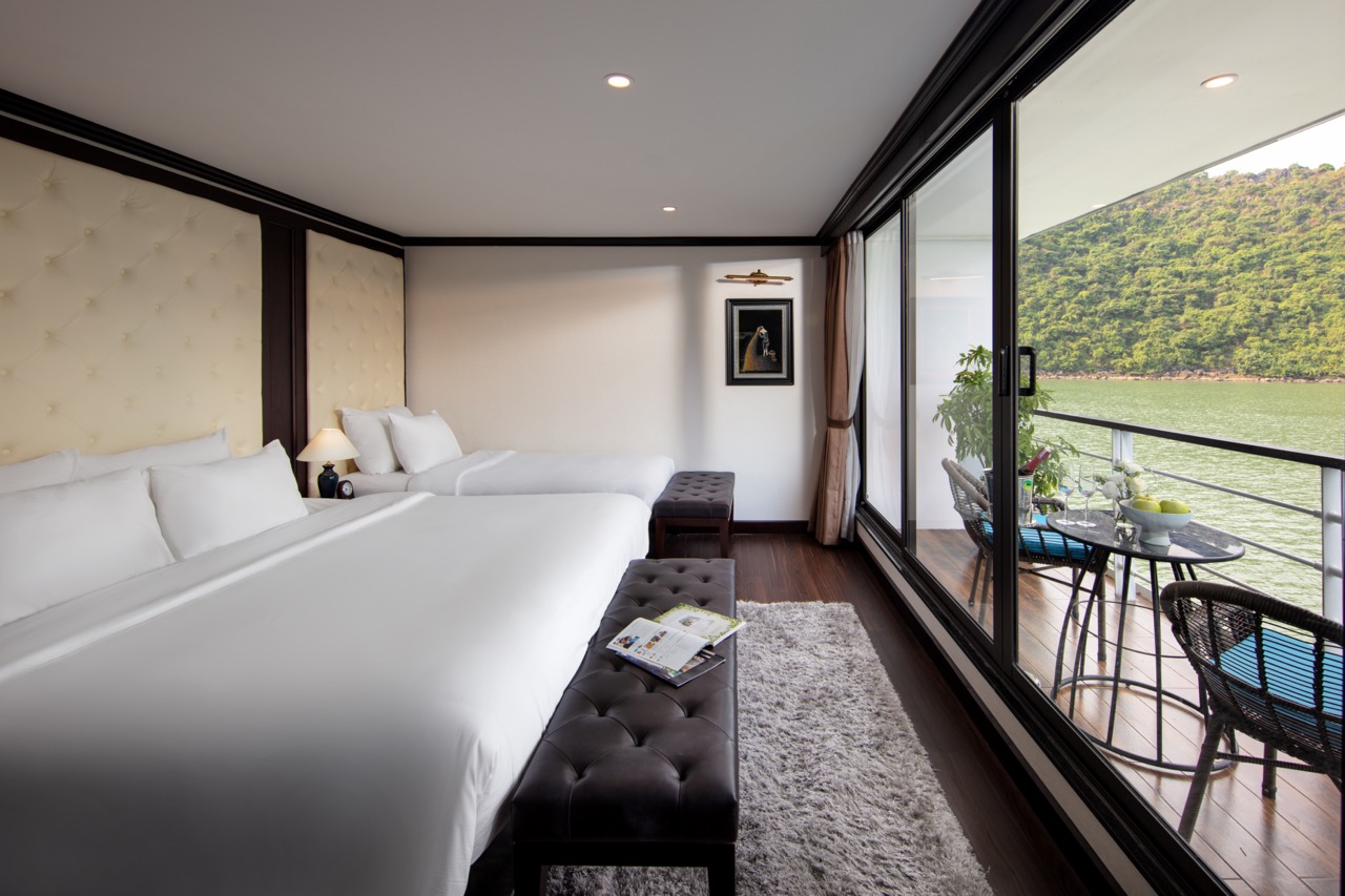 Stunning view of Halong Bay from a cruise balcony with modern interior and serene waterscape.