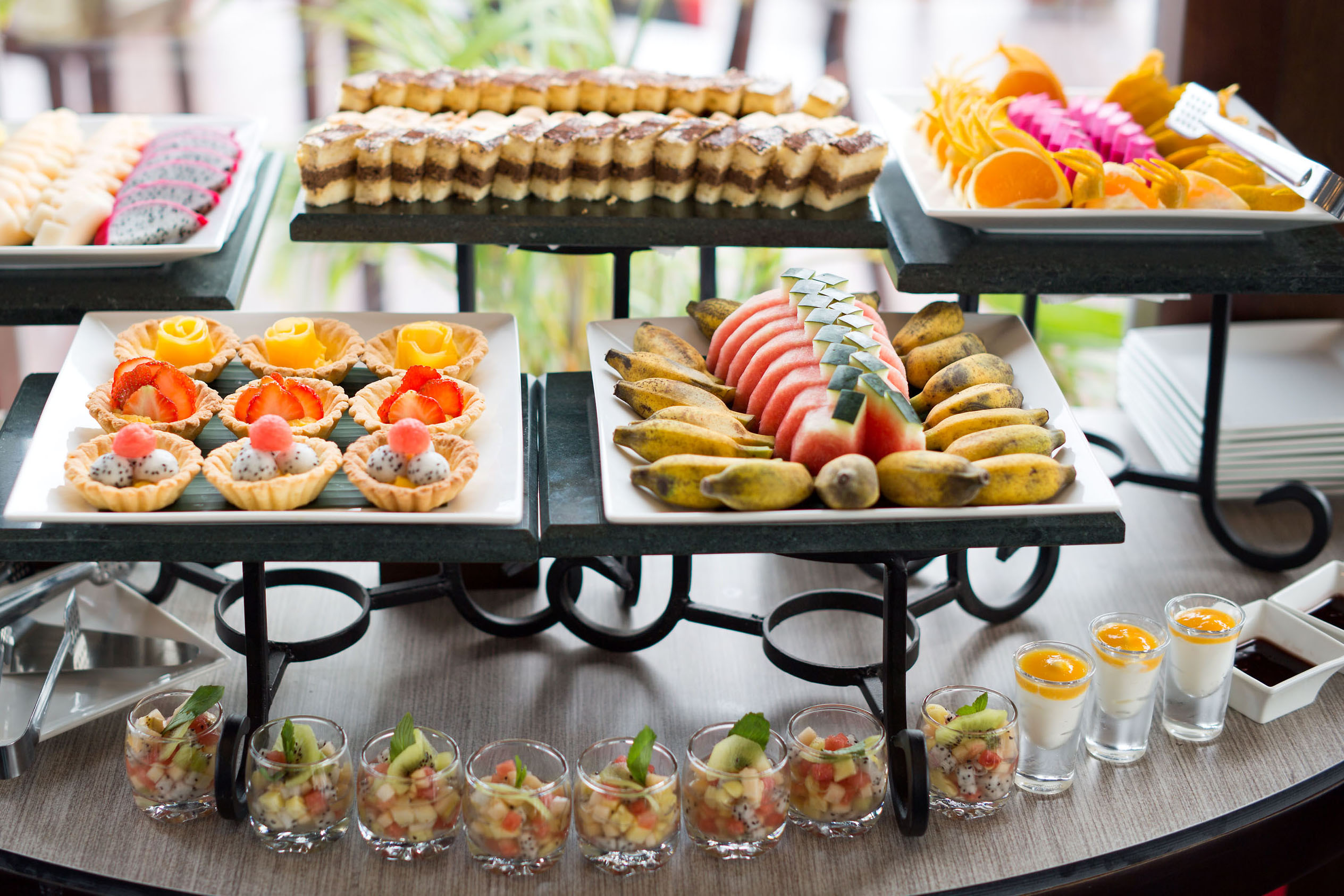 Delicious assorted fruit desserts and pastries for tourists at ViettrendTour buffet.