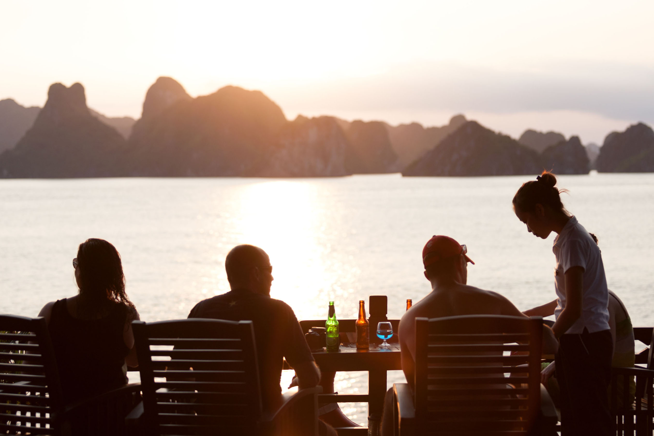 Tranquil sunset dining with scenic island views in Vietnam, perfect for luxury travel and relaxation.