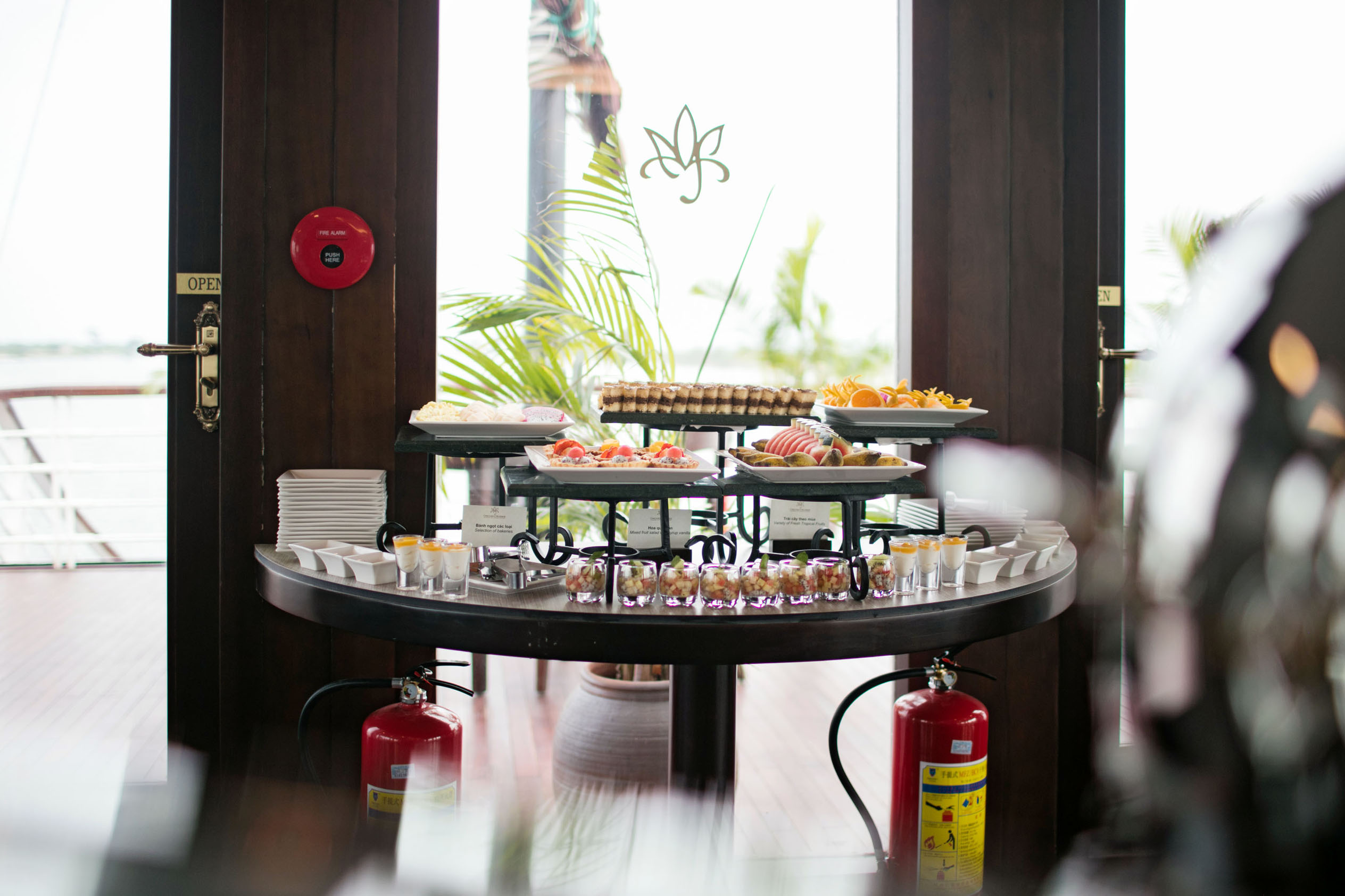 Elegant breakfast buffet with fresh desserts and tropical view at ViettrendTour.