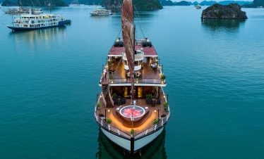Orchid classic cruise halong bay - elegant cruise ship sailing in Halong Bay with stunning limestone islands.