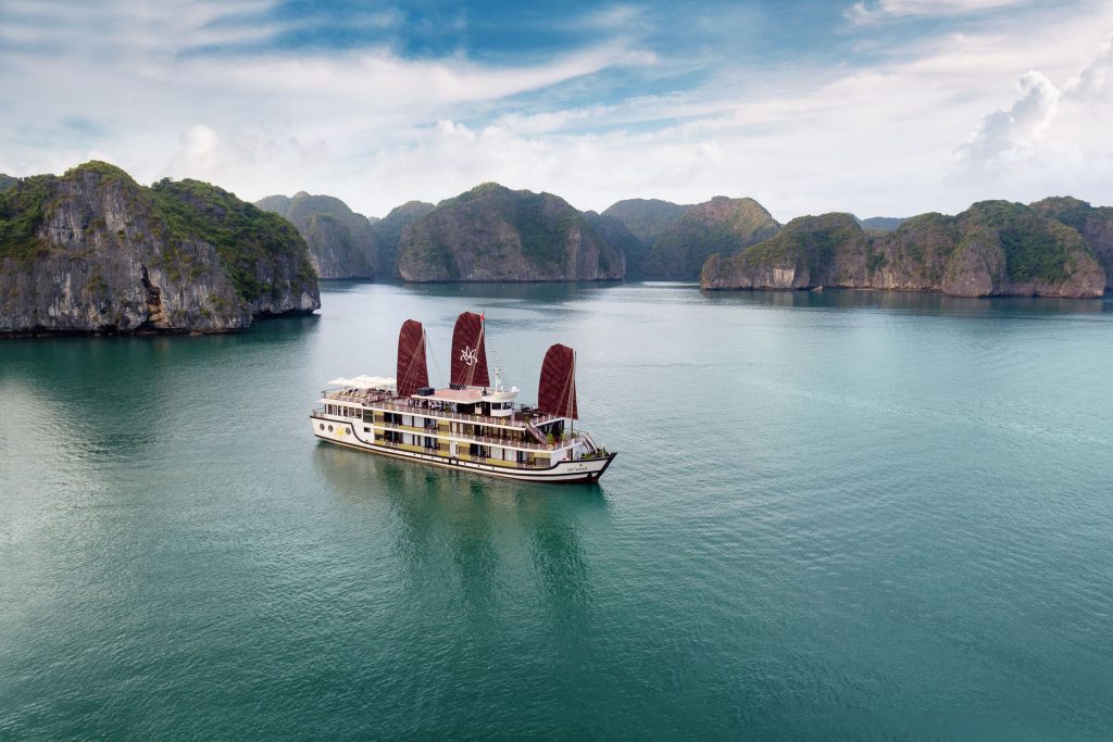 Orchid classic cruise halong bay - a luxurious cruise boat sailing through stunning Halong Bay with towering limestone islands.