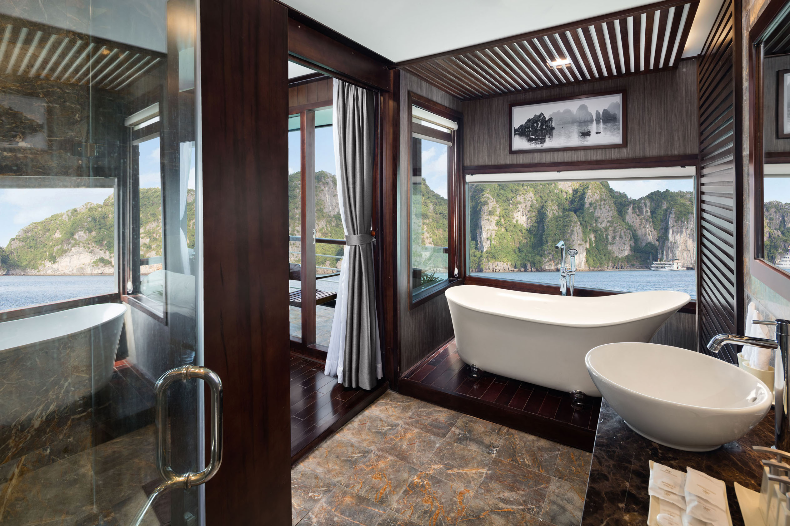 Luxurious river view bathroom with freestanding bathtub on a cruise vessel in Halong Bay Vietnam.