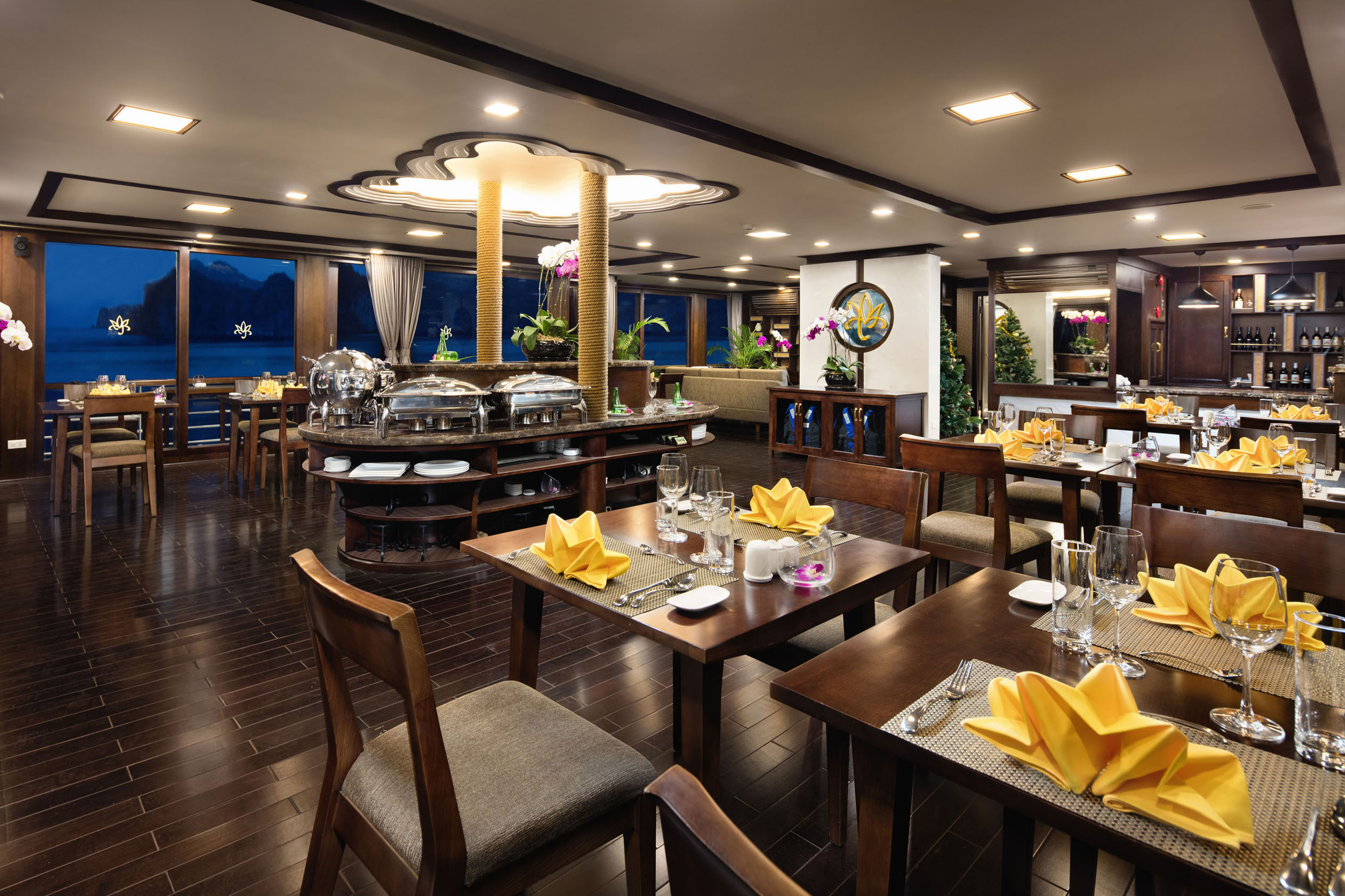 Elegant restaurant interior with festive decor and ocean view, perfect for dining experiences.