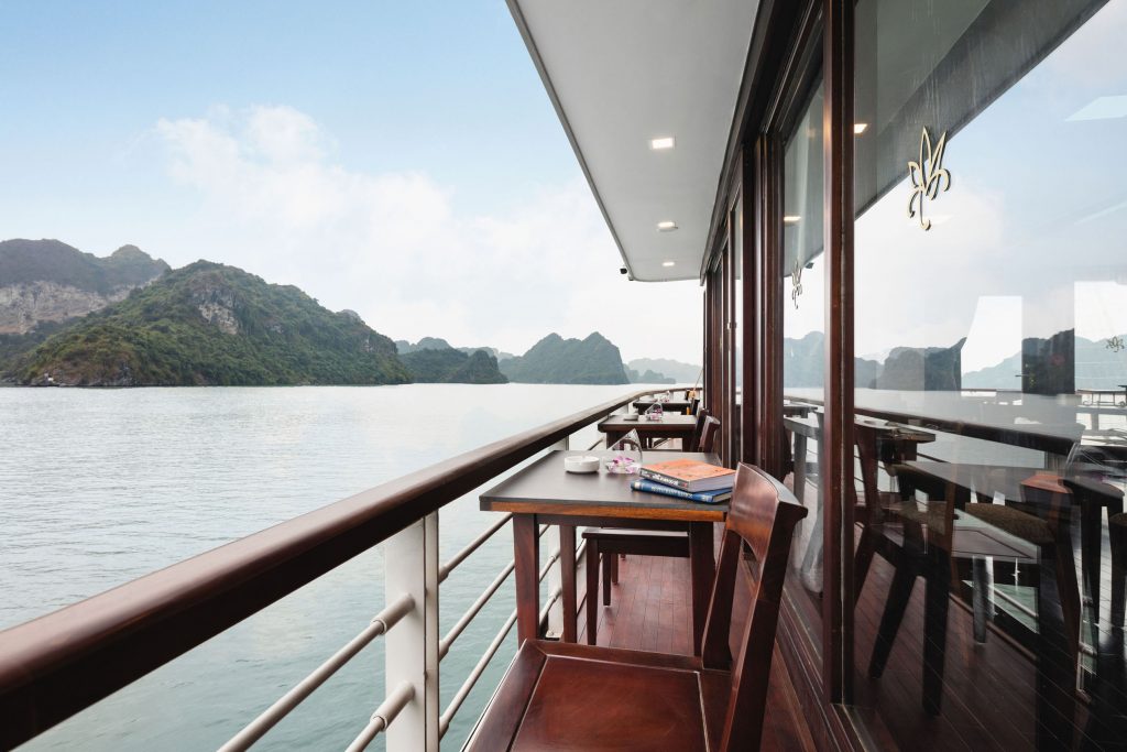 Stunning waterside balcony on a luxury cruise ship with mountain views in Vietnam.