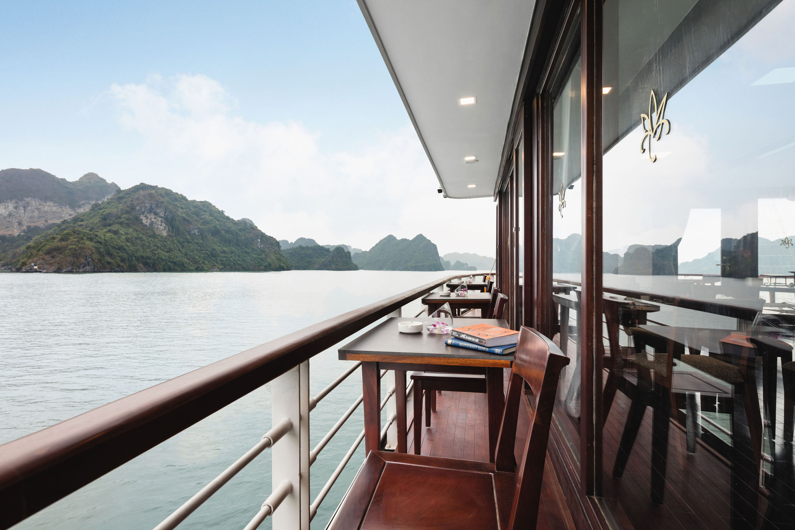 Stunning waterside balcony on a luxury cruise ship with mountain views in Vietnam.
