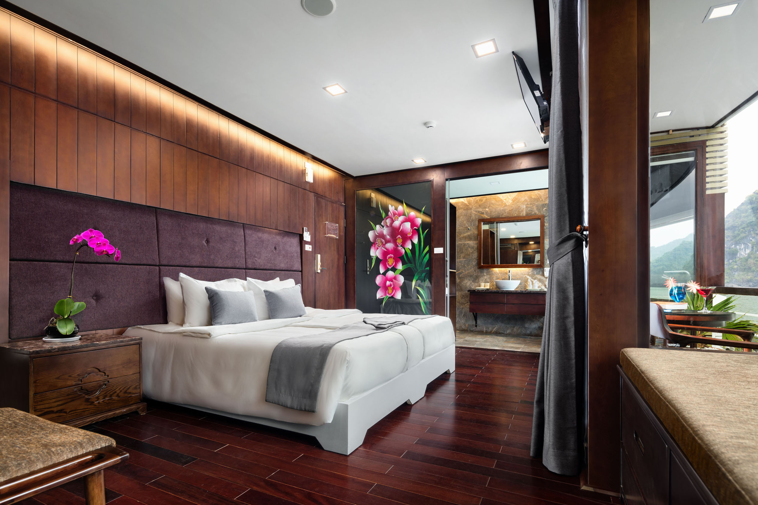 Luxurious hotel bedroom with modern decor and scenic mountain view in Vietnam.
