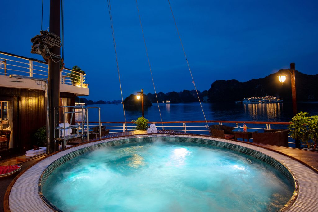 Relaxing night view of a luxury cruise ship hot tub overlooking Halong Bay in Vietnam.