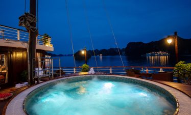 Relaxing night view of a luxury cruise ship hot tub overlooking Halong Bay in Vietnam.