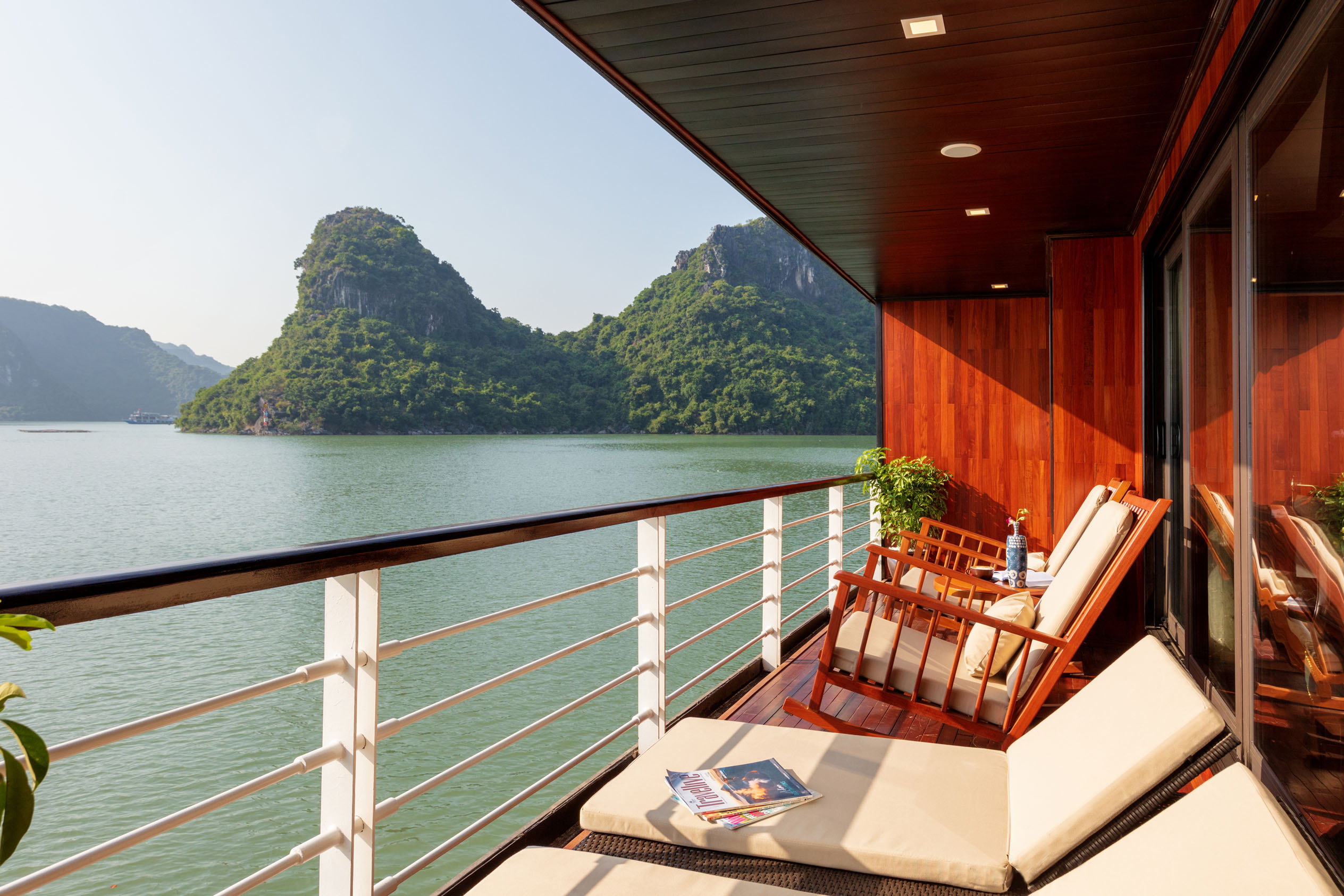 Luxury cruise balcony with view of mountains and river in Vietnam.