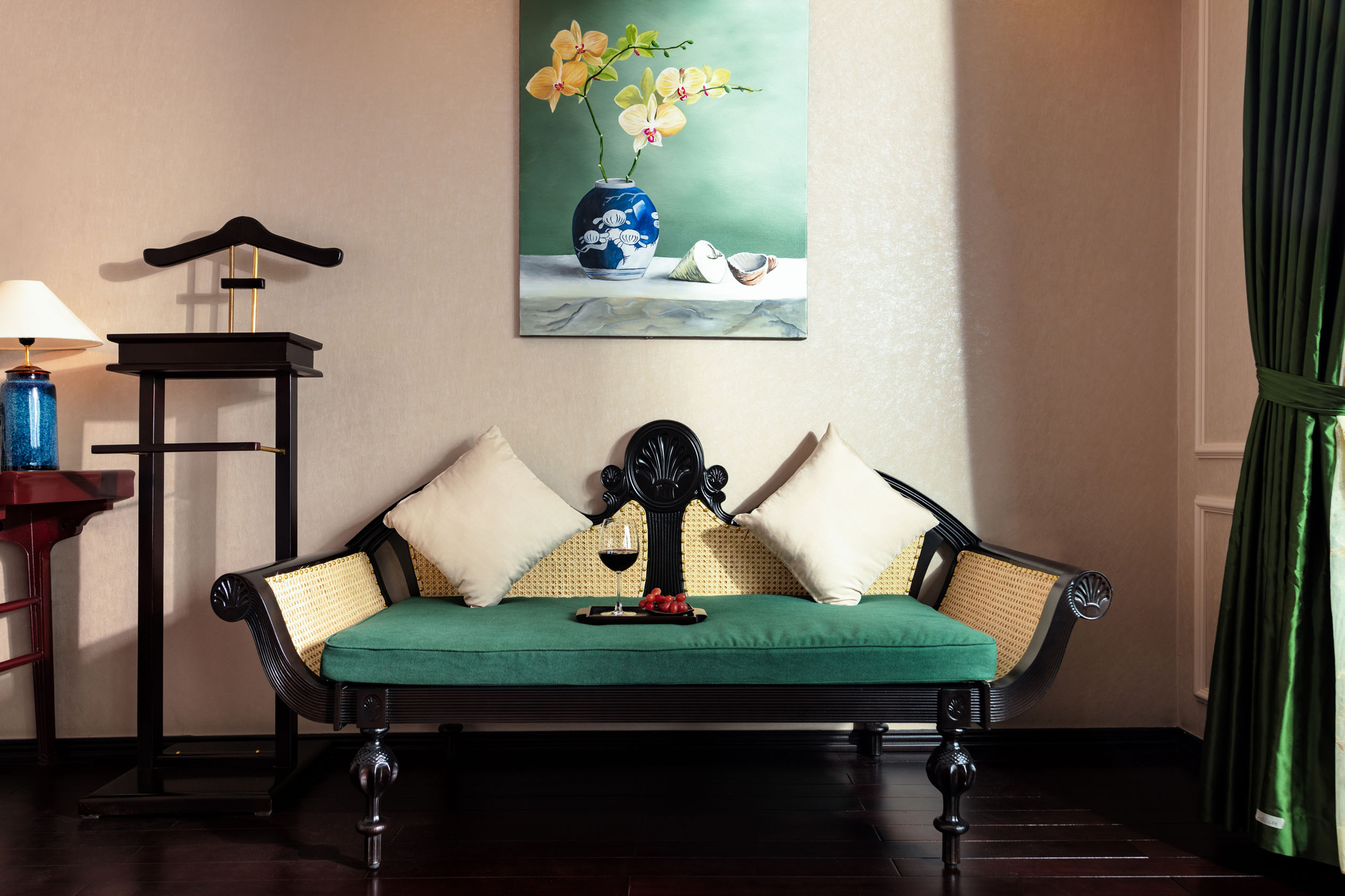 Elegant hotel lounge with vintage sofa, wine, and artwork for luxury travel experiences.