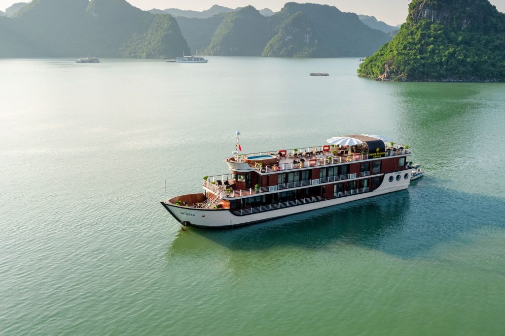 Luxury cruise on Ha Long Bay, Vietnam, with stunning limestone islands and emerald waters.