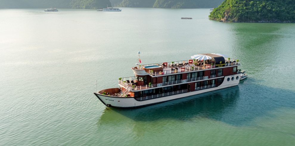 Luxury cruise on Ha Long Bay, Vietnam, with stunning limestone islands and emerald waters.