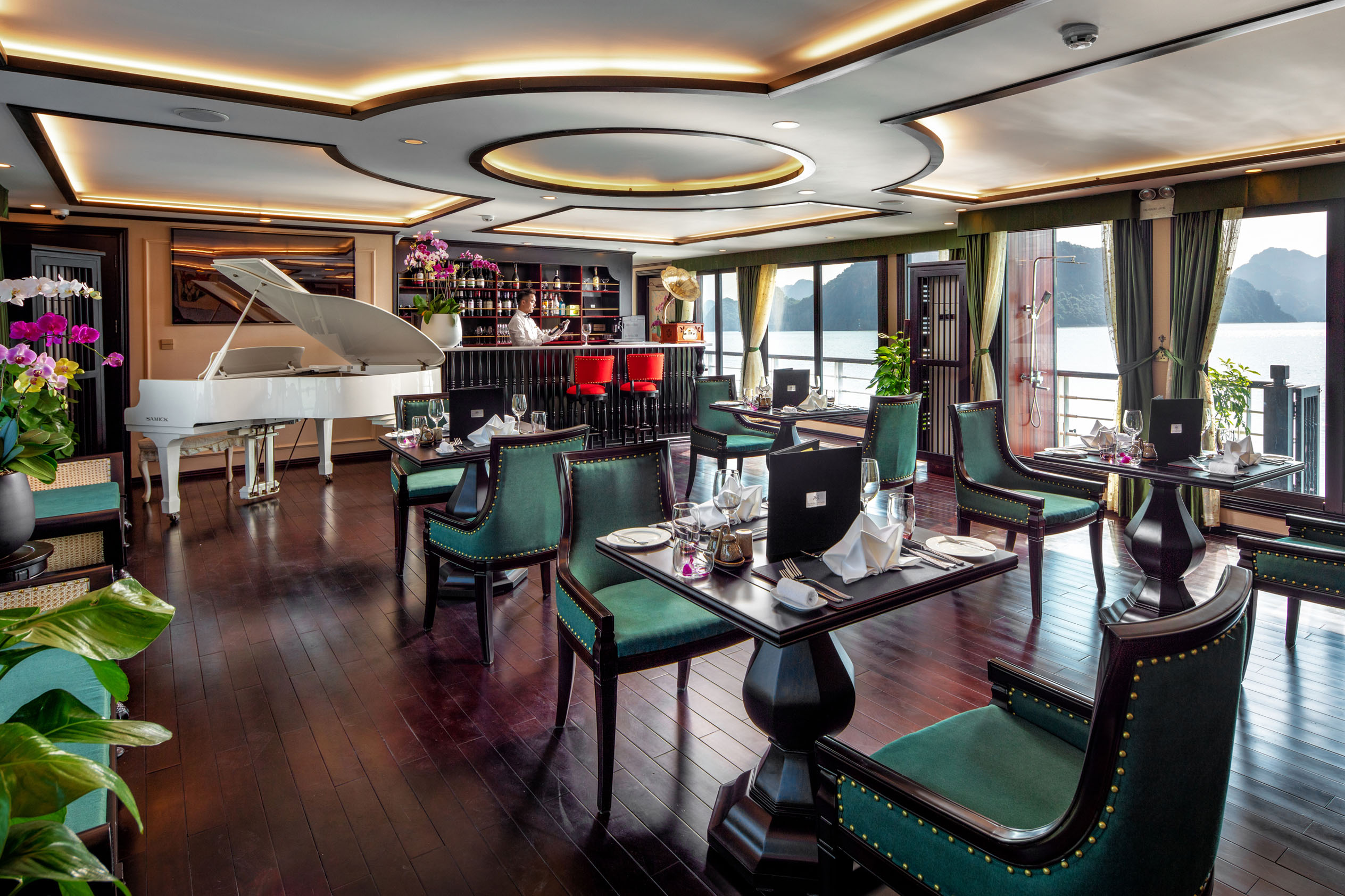Elegant waterfront restaurant with sea view, elegant decor, and live music ambiance.