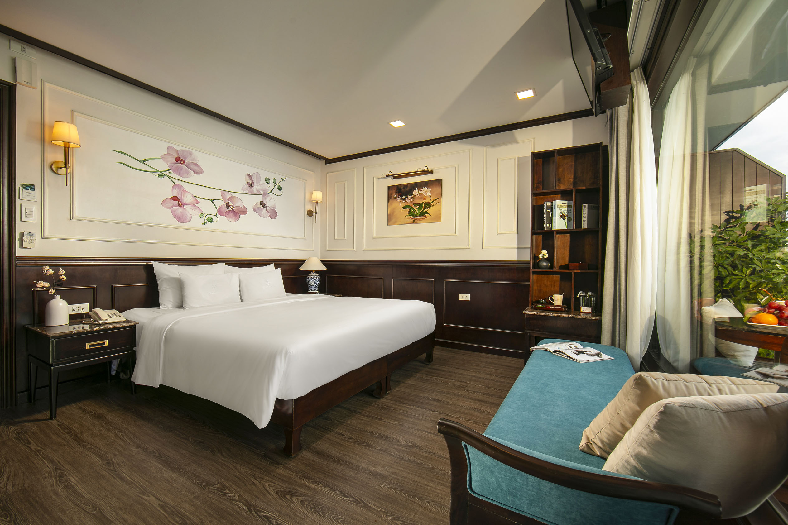 Luxurious hotel room with elegant decor, floral artwork, and modern amenities for a relaxing stay.