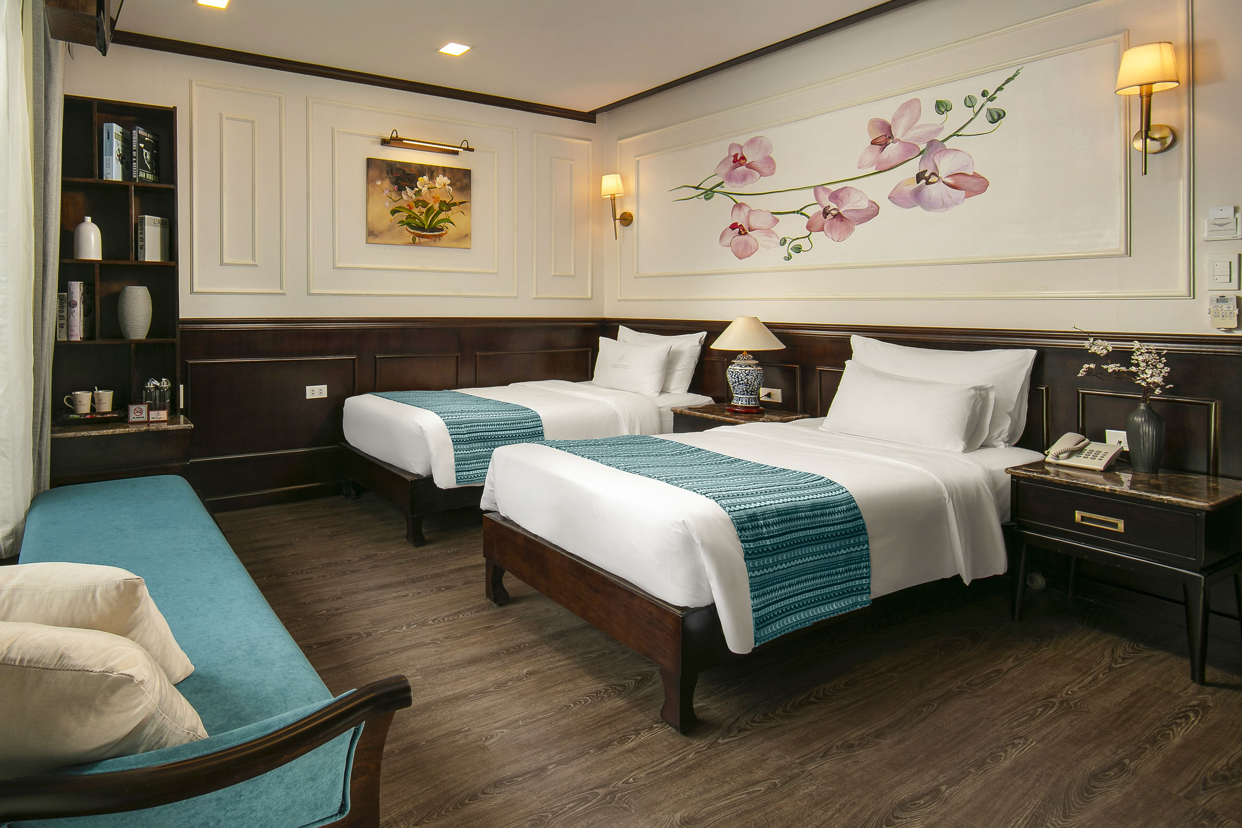 Comfortable hotel room with two twin beds, elegant decor, and modern amenities for a relaxing stay.