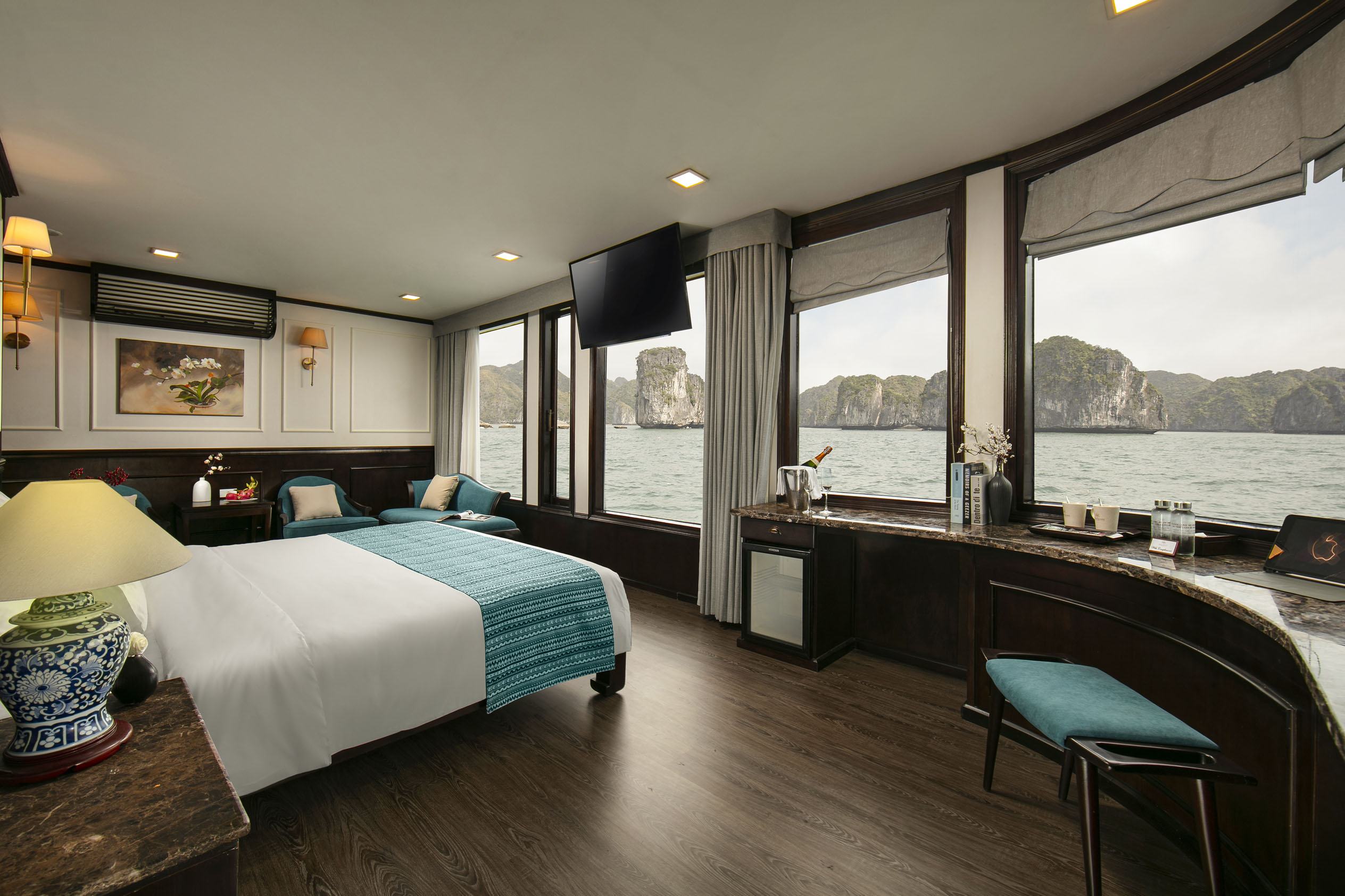 Luxurious hotel room with stunning bay view and elegant decor, perfect for a relaxing getaway.