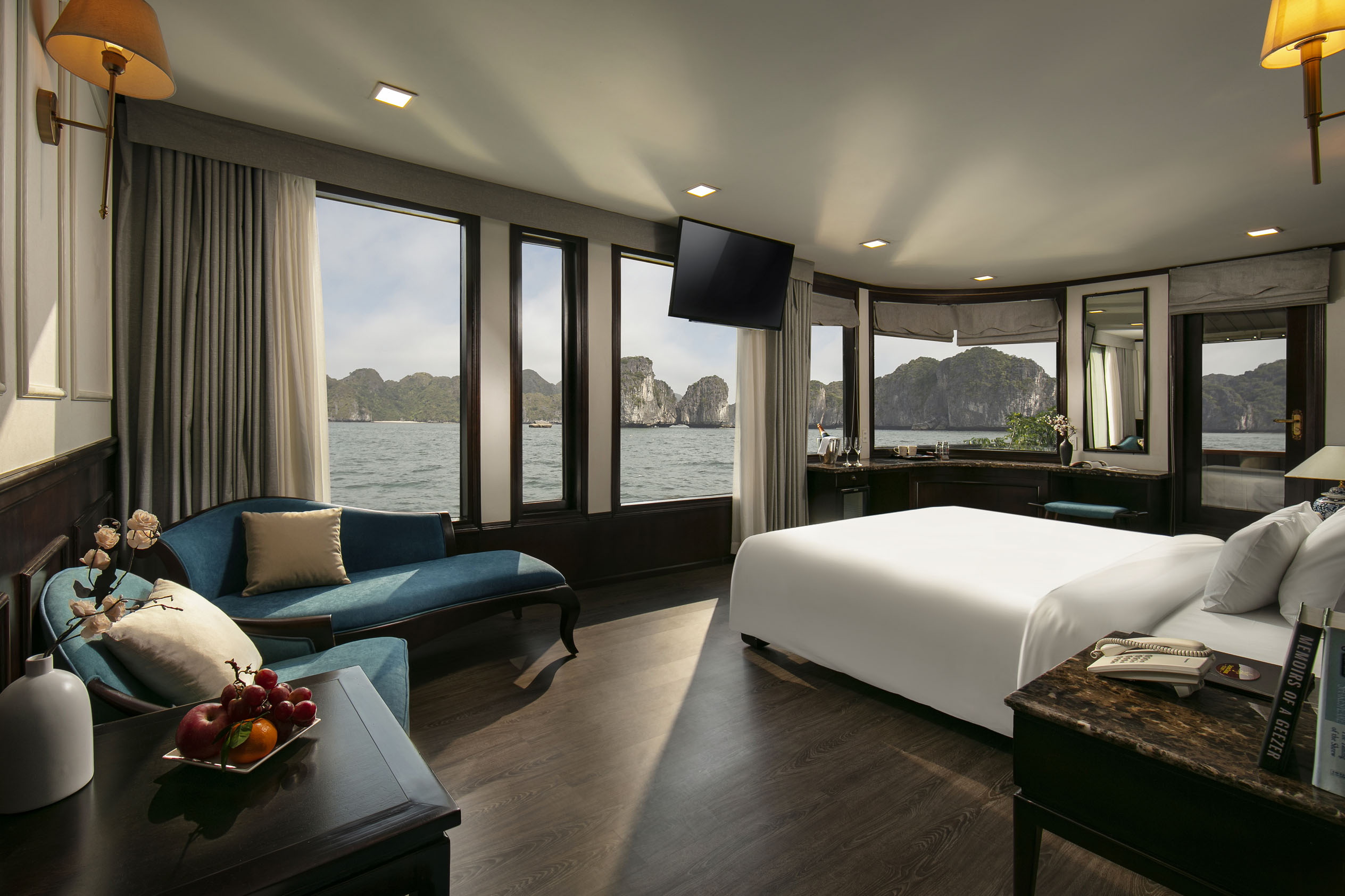 Luxurious bay-view hotel room with modern amenities and elegant decor, overlooking stunning limestone islands.
