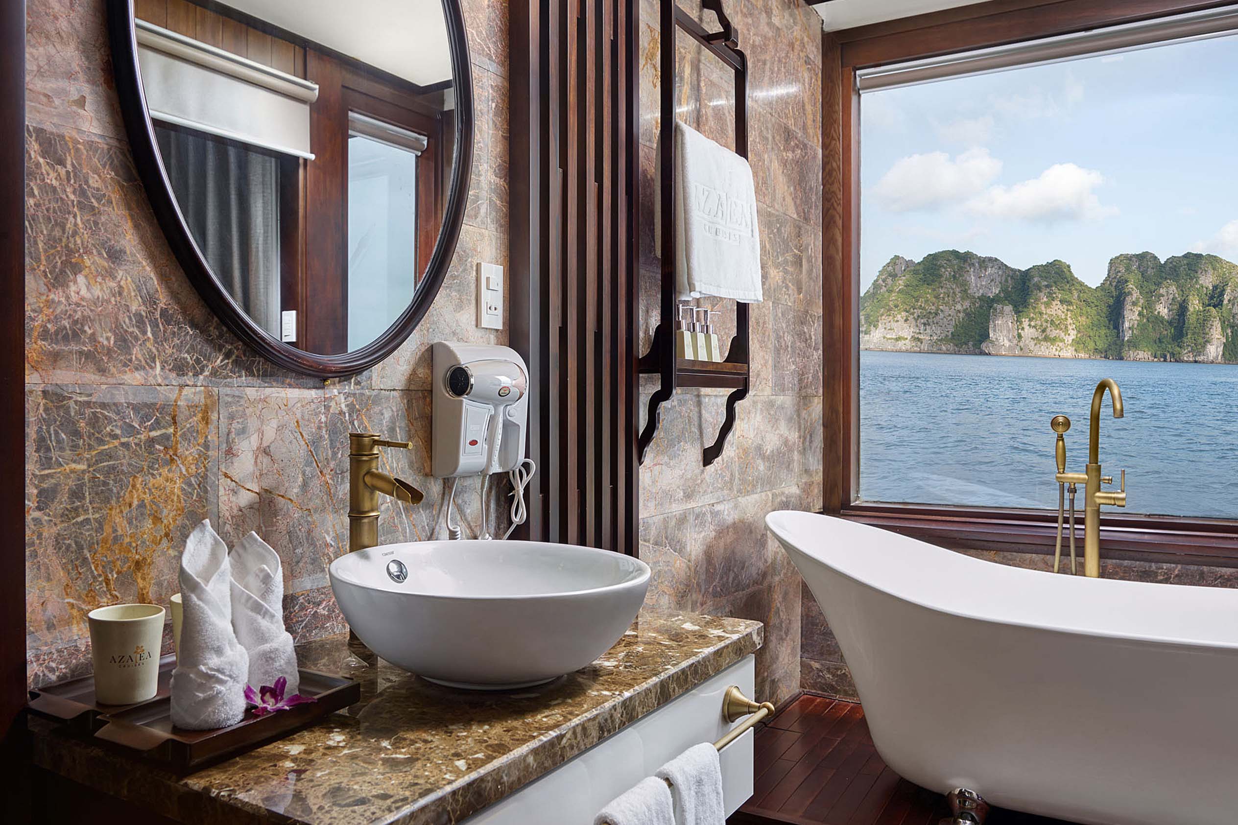 Luxurious ocean-view bathroom with freestanding bathtub and marble accents, ideal for relaxing in Vietnam.