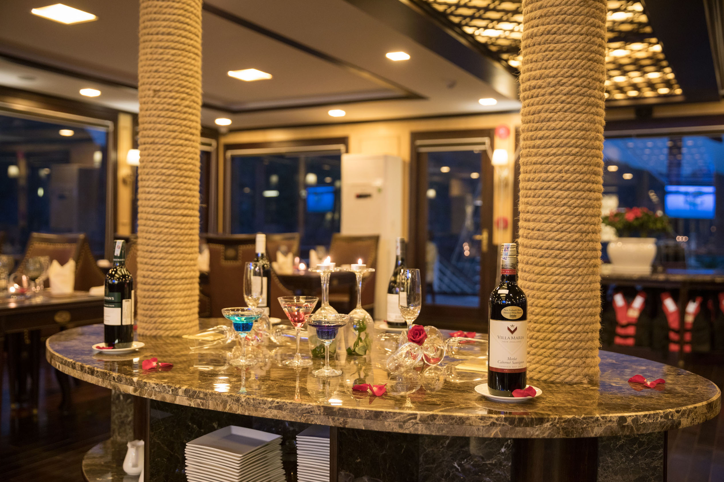 Elegant restaurant interior with romantic wine and candle setup for special occasions.