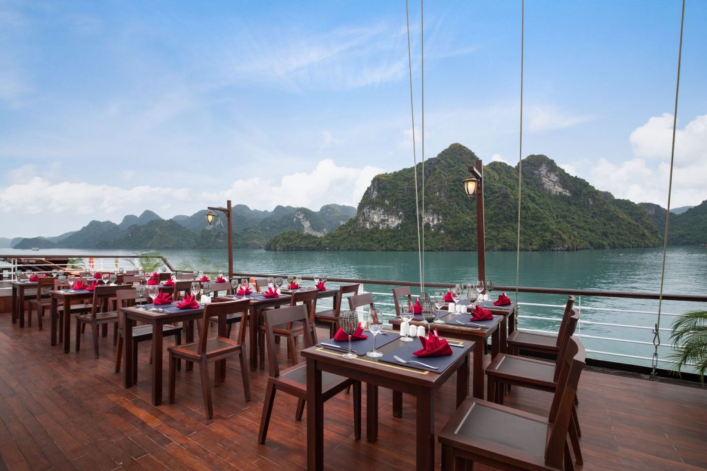 Elegant waterfront restaurant with mountain views in Vietnam, ideal for luxury dining and sightseeing.
