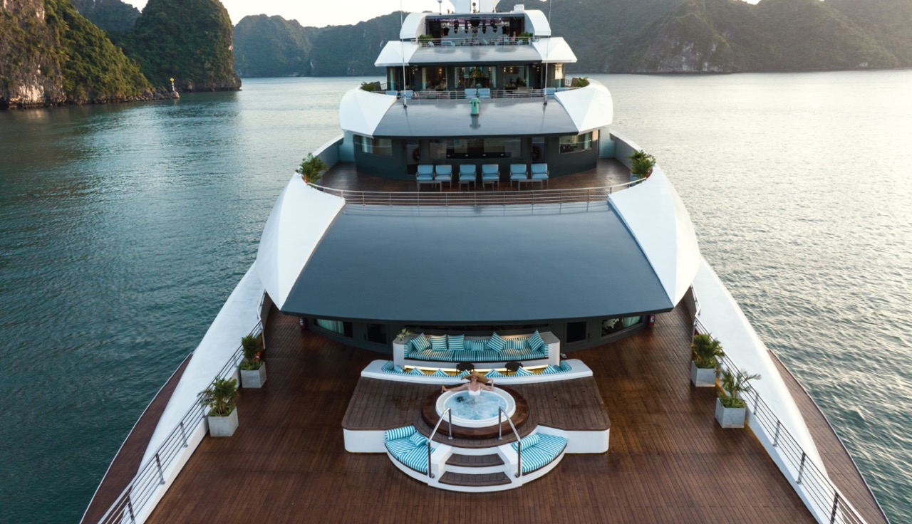 Luxury yacht with spacious deck and panoramic views in Halong Bay, Vietnam.