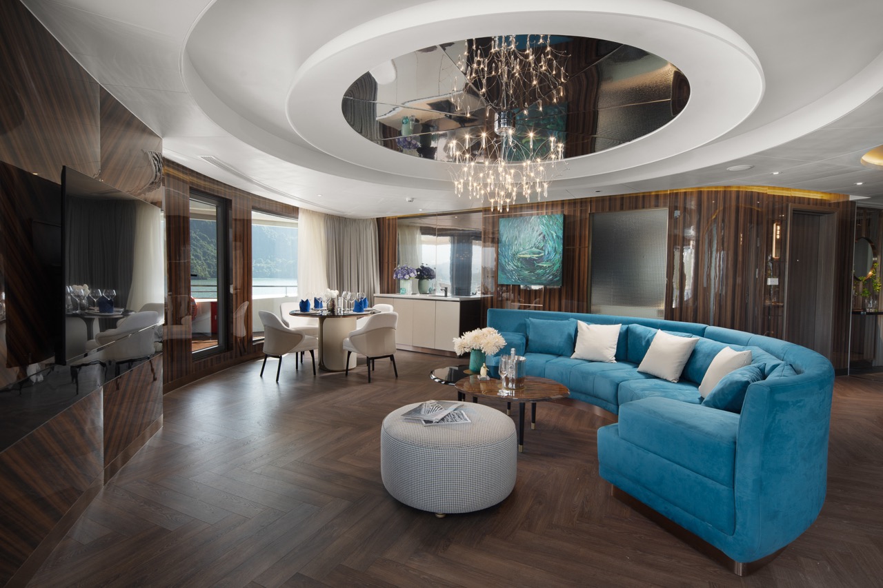 Luxurious hotel living room with modern decor and panoramic window views.