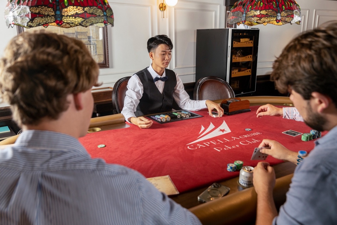 Elegant poker game at Cape La Cruz Poker Club, with players engaged around a luxurious table.