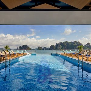 Luxurious rooftop infinity pool with sea view and island scenery in Vietnam.