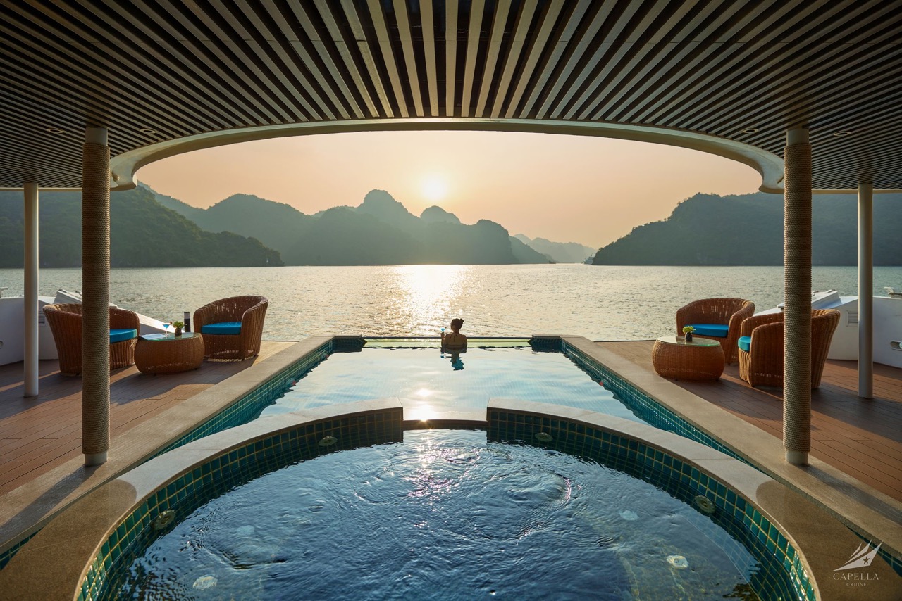 1. Luxurious infinity pool with stunning sunset over mountains and lake in Vietnam.