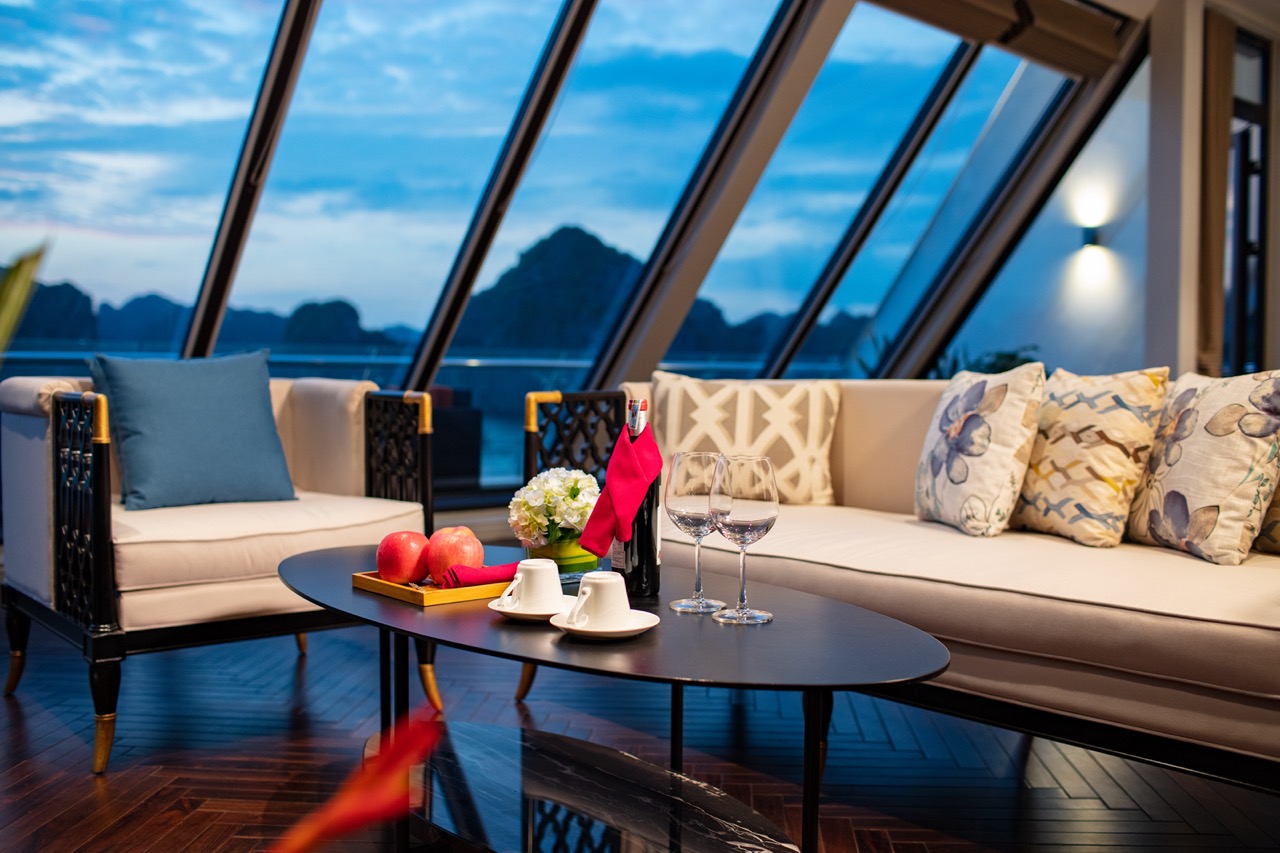 Luxurious indoor lounge with panoramic mountain views, elegant furniture, and stylish decor.