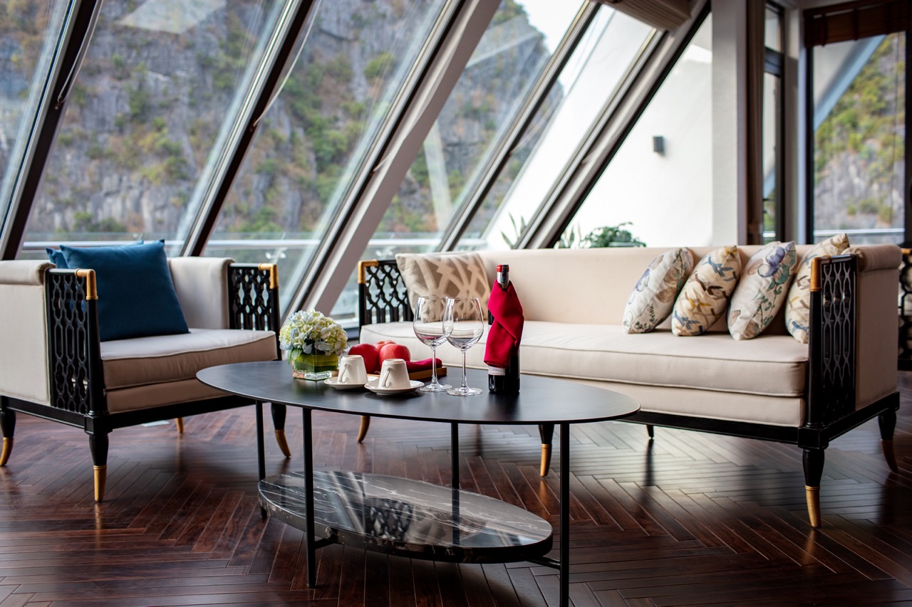 Luxurious modern lounge with scenic mountain views, stylish furnishings, and elegant decor for upscale travel experience.