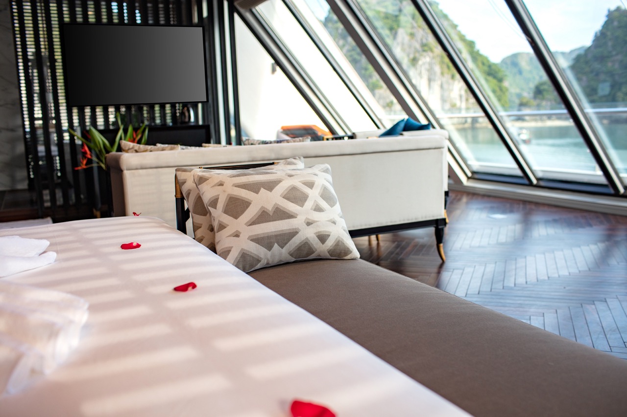 Luxurious cruise room with panoramic river views and elegant decor for Vietnam travel experiences.